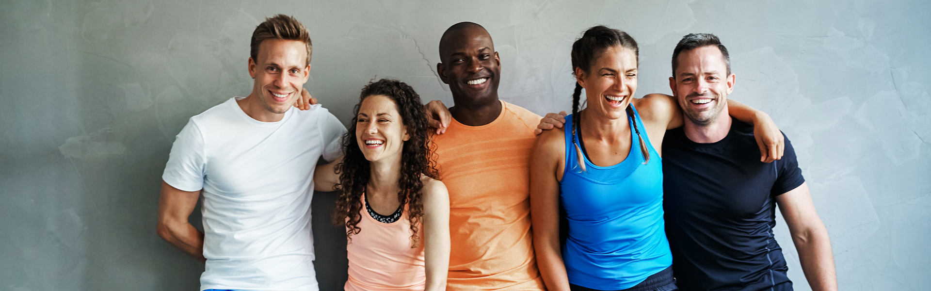 A group of athletic friends smiling