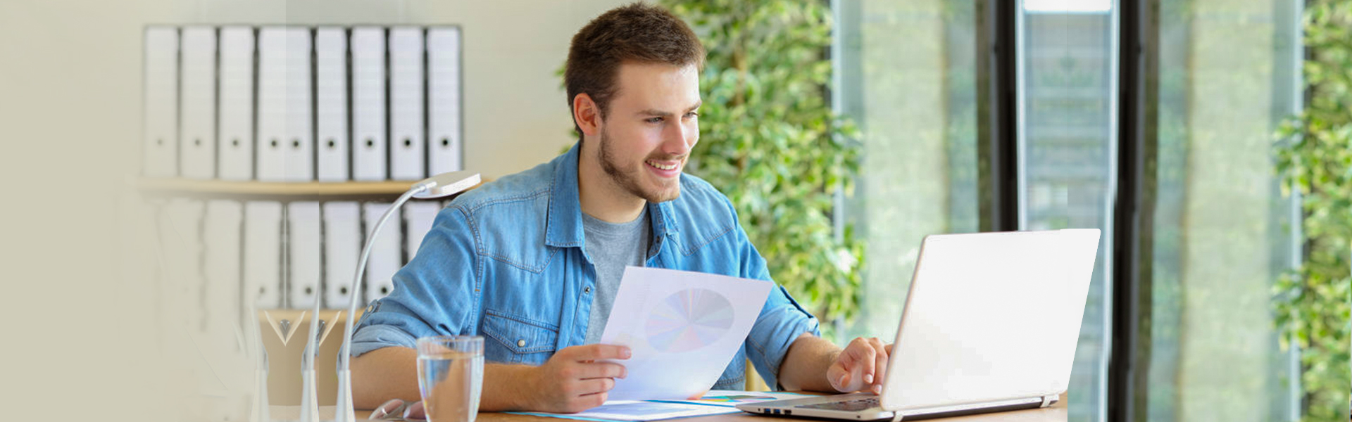 Smiling man conducting email marketing